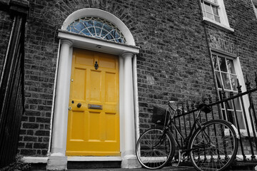 Fototapeta na wymiar The door nearby - traditional entrance in Dublin, Ireland. The sign on the door says 