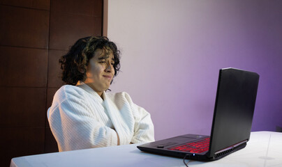 person crying with coat on laptop 