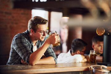 Having fun. People in casual clothes sitting in the pub