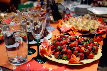 Plate with ripe strawberries. Beautiful festive table setting. Selective focus
