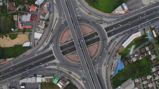 Aerial view of cars driving on highway or moterway at night. Overpass bridge street roads in connection network of architecture concept. Bangkok, Thailand
