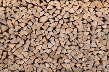 Birch firewood stacked in rows front view