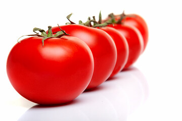 Juicy ripe red tomatoes on a white background