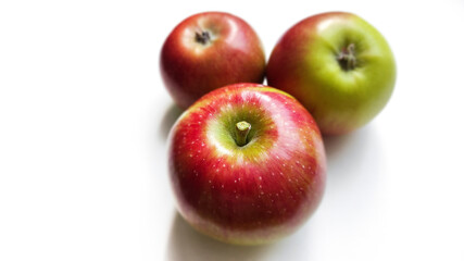 Red and green apples on a white background. Close-up. Selective focus with copy space.