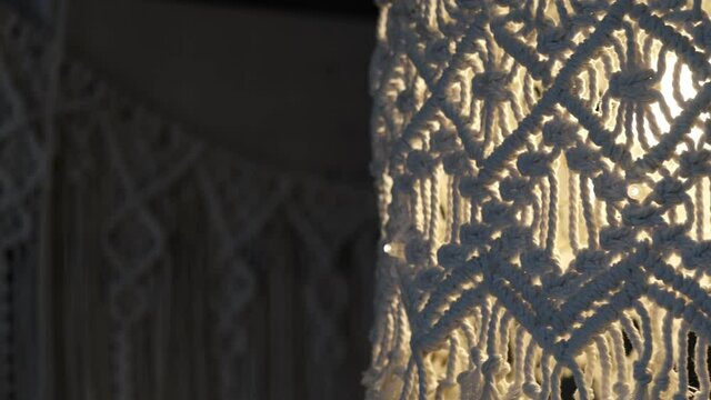 handmade macrame lampshades hanging open design in natural colours.boho style shell shade For a lamp. on black background. Close up video. Slow motion video. stock footage.