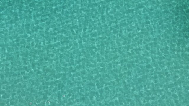 Blue water in the swimming pool with light reflections. Slow motion Pure blue water in pool with light reflections. 