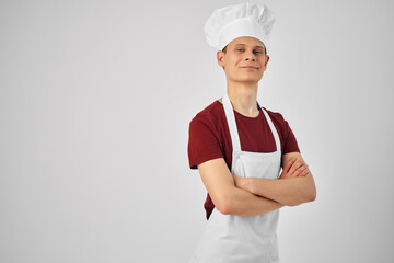 man chef aprons with a cap on his head light background Professional