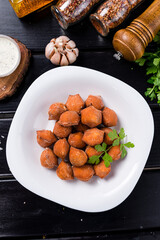 Traditional fried pelmeni, ravioli, dumplings filled with meat on black background, copy space.