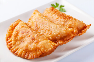 Close up of tuna patty, empanadillas, on white background