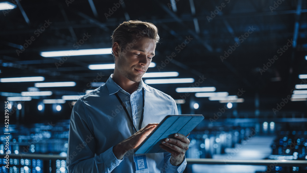 Aufkleber Portrait of Handsome Smiling IT Specialist Using Tablet Computer in Data Center, Looking at Camera. Succesful Male e-Business Engineer Working in Big Server Farm Cloud Computing Facility.