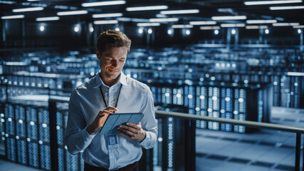 Portrait of Smiling IT Specialist Using Tablet Computer in Data Center. Big Server Farm Cloud...