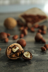 a composition of nuts on the table.the picture has brown-gray tones and a bright accent on the walnut kernel