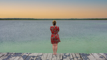 girl watching the sunset in the lagoon