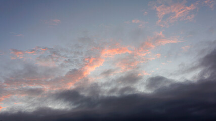 Fototapeta premium sky sunset with gray and pink clouds with blue background