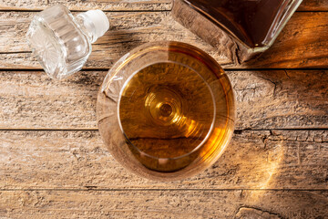 Fototapeta na wymiar Cognac or whiskey drink on rustic wooden table