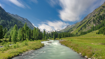 Fototapeta na wymiar River flowing down from a glacier in the Swiss Alps.