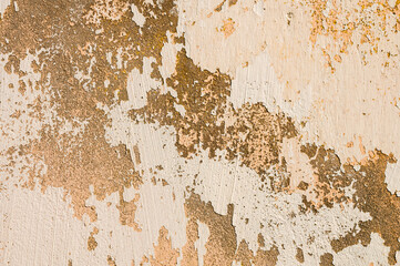 The old cement wall, painted and putty, peels off and collapses. Grunge background texture