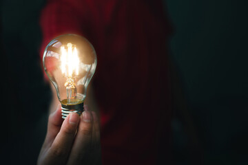 Close-up of a man's hand holding a light bulb This is a conceptual picture that shows what a good idea can be.