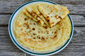 Bakery. Home made pancakes with   organic free range  eggs and white cheese on wooden background. Rustic style breakfast