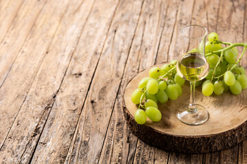 Italian golden grappa drink on wooden table. Copy space