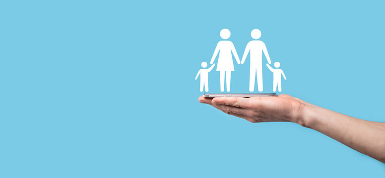 Hand Hold Young Family Icon. Family Life Insurance,supporting And Services,family Policy And Supporting Families Concepts.Happy Family Concept.Copy Space.mancupped Hands Showing Paper Man Family