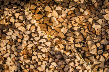 Wall firewood , background of dry chopped firewood logs in a pile