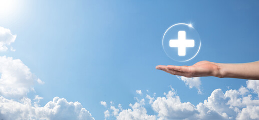 Businessman hold virtual plus medical network connection icons. Covid-19 pandemic develop people awareness and spread attention on their healthcare.