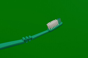 new green toothbrush on green background