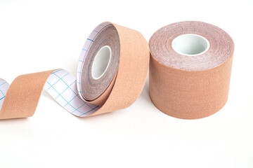 two pieces of lifting or kinesio tape rolls on white surface