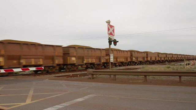 iron ore train passes a rail crossing at port hedland in western australia