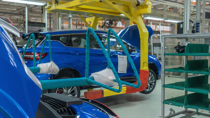 Car Production line. Assembling cars at conveyor assembly line. Modern Assembly of cars at the plant. The automated build process of the car body. Industrial concept.