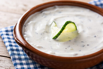Traditional Greek Tzatziki on wooden table. Close up