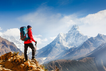 Fototapeta premium Hiker enjoying the view on the Everest trek in Himalayas, Ama Dablam mountain view, Nepal