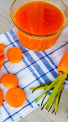 Glasses of carrot juice with vegetables on table close up. Vertical mobile format 9:11 for smartpone, stories,