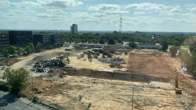 Construction site from above with digger power showel working and driving trucks, destroyed ware house Eschborn close to Frankfurt