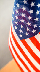 American flag on the table, part overexposed and blurry, the independence of America, the great power USA