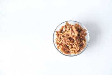 walnut on a plate on white background , top view 
