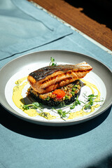 Gourmet salmon fillet with creamy basil sauce and black rice