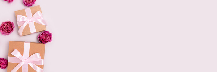 Banner with gift boxes and pink rose flowers on a gray background. Romantic composition with place for text.