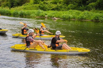 Two pairs of kayakers are gettin ready for kayaking