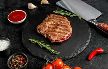 Ribeye grilled steak on stone background 