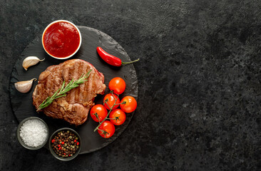 Ribeye grilled steak on stone background with copy space for your text