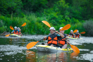 Male kayakers kayaking together