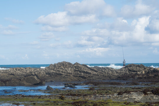 fisherman on Tagle beach rocks
