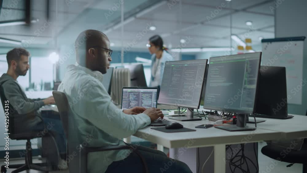 Aufkleber Multi-Ethnic Office: Black IT Programmer Working on Desktop Computer. Male Specialist Doing Website, Software Engineer Developing App, Program, Video Game. Terminal with Coding Language. Static Shot