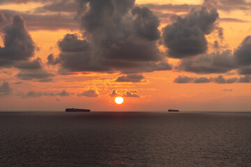 Mystical and inspirational beautiful sunset cloudy sky, over the calm ocean.