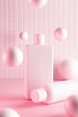 Cosmetic bottles with flying balls in a pink neon light, mock up