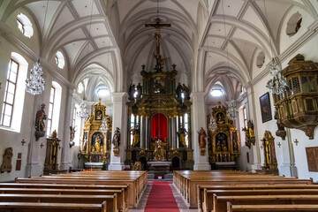 Fototapeta na wymiar Great view of the high altar as well as the two smaller side altars next to each other on the same wall sides inside the parish church of St. Andreas in Berchtesgaden, Bavaria, Germany.