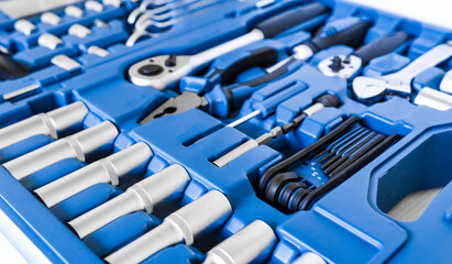 Close-up of chrome shiny tools in a blue storage case. Repair and construction, equipment for work at a car service.