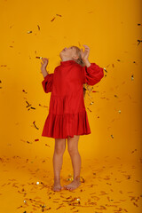 Fototapeta premium beautiful happy blonde girl in a red dress is happy jumping holiday birthday